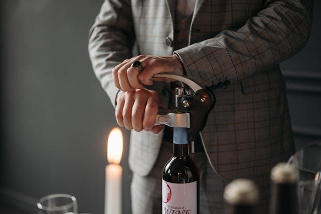 Wine bottle being opened with a lever pull cork screw